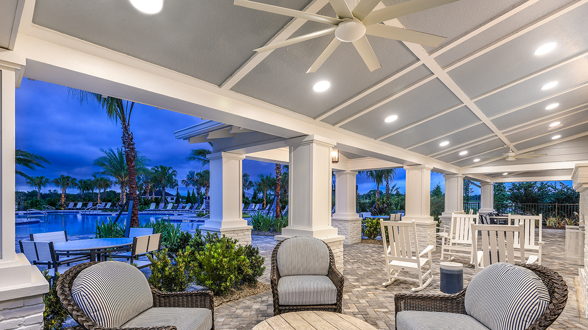 Open-air pavilion at blue hour overlooking the resort pool — Canoe Creek Amenity Center
