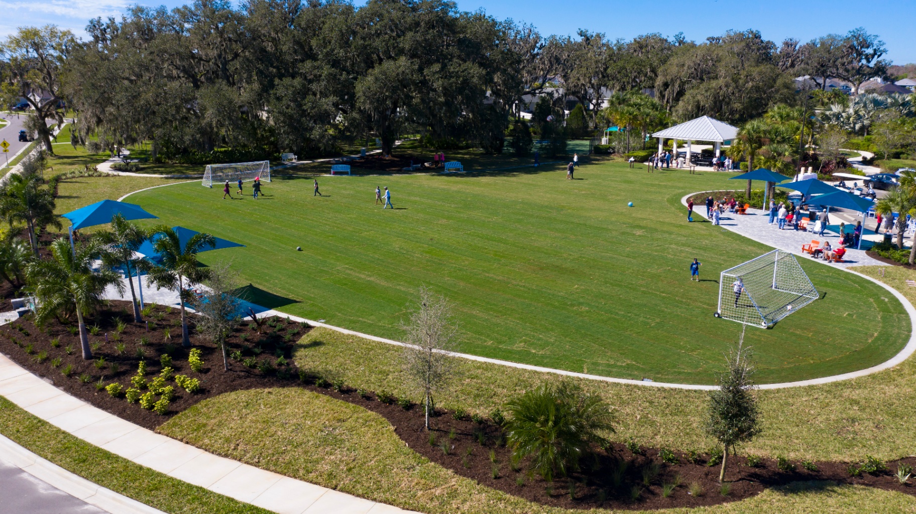 Aerial view of Silverleaf Symphony Park open lawn with soccer goals, shaded seating, and pavilion