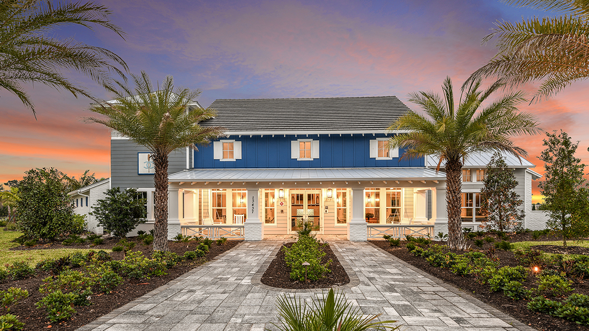 Canoe Creek Amenity Center at dusk — welcoming clubhouse with palm-lined entry and coastal landscape